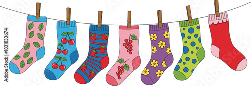 Colorful cute patterned socks hanging on clothesline with playful fruit and floral designs for fun children’s vector illustration
