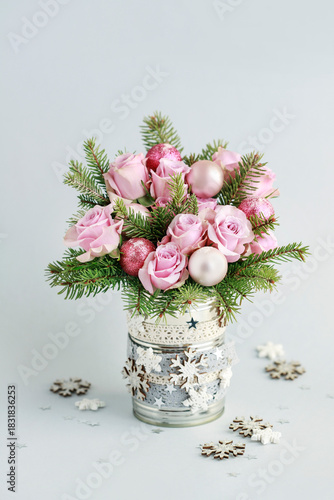 Modern Christmas pink decoration with roses, fir and baubles. Postcard motif.