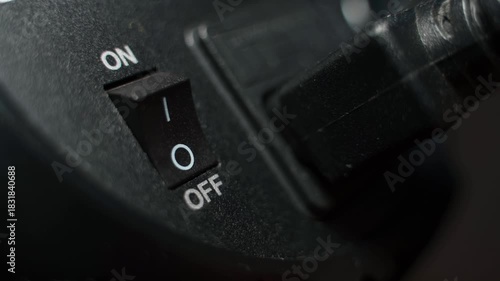 finger presses on off button close-up. Turning on and off an electrical appliance