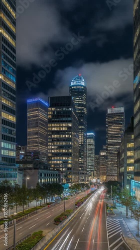 Timelapse cars passing a financial district skyline at night for modern urban business visuals