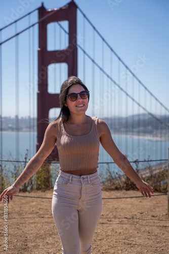 Happy woman enjoying a sunny day near the Golden Gate Bridge, San Francisco