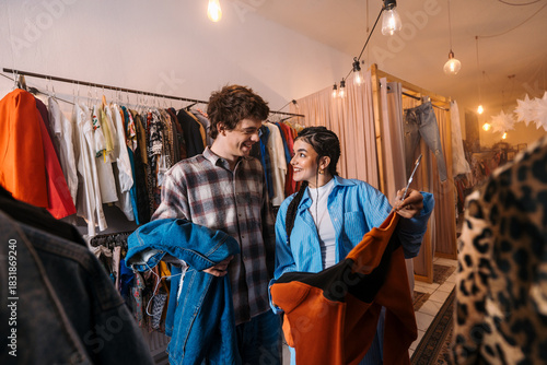 Fashion Trend Exploration: Friends Trying On Stylish Outfits in a Boutique