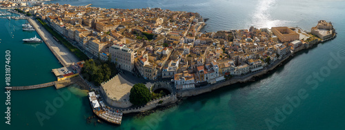 Panoramic aerial view of the island of Ortygia. This is the location of the historic center of Syracuse, Sicily, Italy. The city overlooks the Mediterranean Sea and contains many historical landmarks.