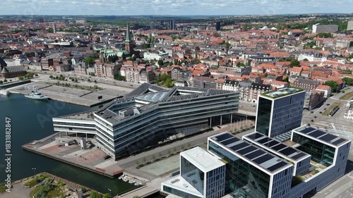 Aerial view of Aarhus cityscape, flying over modern architecture landmarks in the Aarhus Docklands neighbourhood on a sunny day in Denmark. 