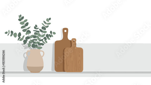 Charming eucalyptus branches in vase with wooden cutting boards create a warm and inviting minimalist kitchen scene with rustic charm