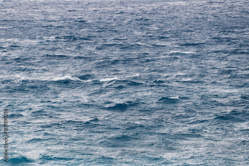 Vast ocean waves under cloudy sky with choppy waters