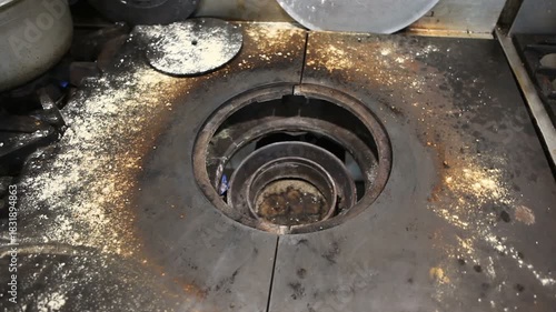 Dirty gas stove wok after cooking.