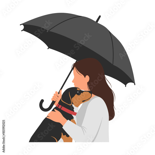 Woman holding black dog under an umbrella while enjoying a winter walk  