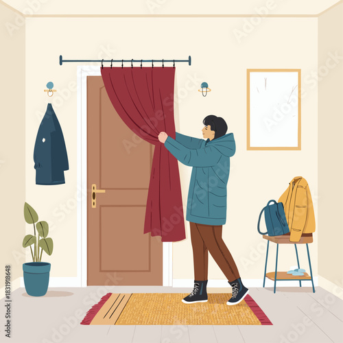 Un hombre corre una cortina gruesa delante de la puerta de entrada, preparándose para el frío invernal en el interior de una casa.
