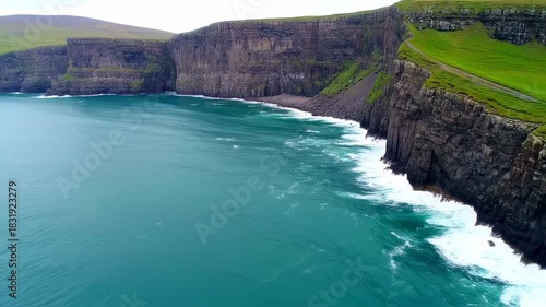 Dramatic coastal cliffs meet turquoise ocean waves