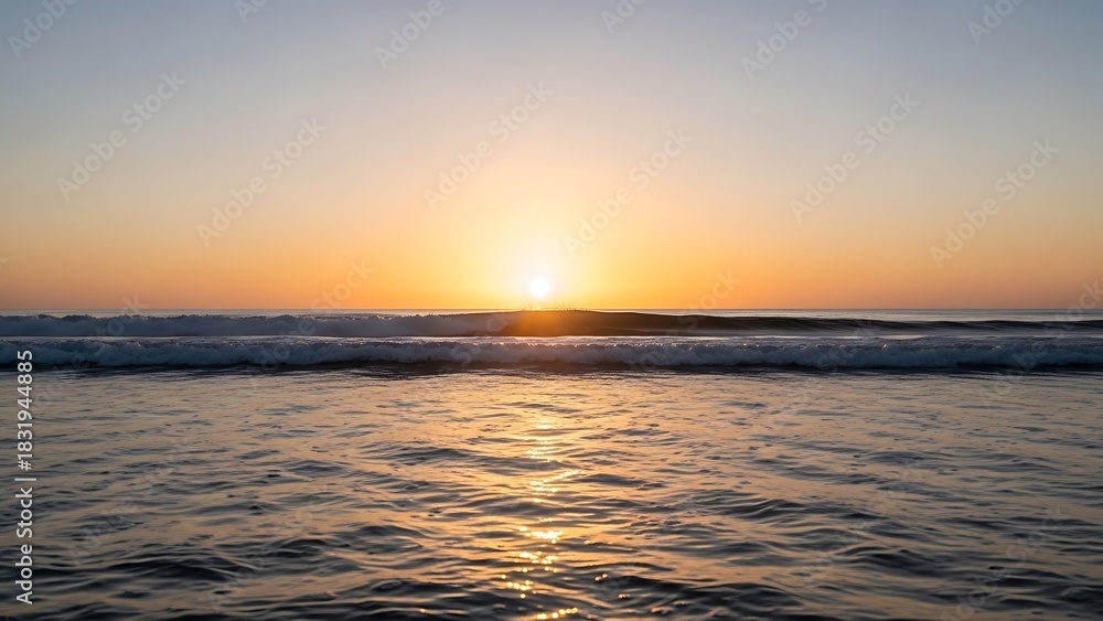 Fototapeta premium Calm ocean water with a bright sunset and sun reflecting on the surface waves
