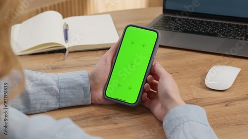 Woman use digital tech cell phone green screen mock up talk video call. Hand press click phone web site middle center. Girl hold mobile. Chroma key page. Cozy home background. Online app copy space.