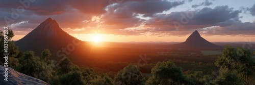 Breathtaking sunset over glass house mountains, lush forest, scenic horizon