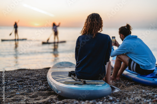 Two people enjoying a calm sunset together, capturing an authentic travel vibe filled with warmth