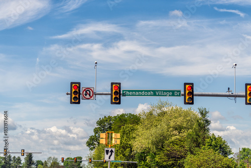 Fototapeta Naklejka Na Ścianę i Meble -  Waynesboro, Virginia small town city street with red traffic light sign for Shenandoah Village drive shopping center with blue sky and clouds