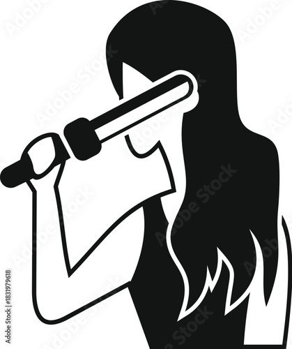 Woman styling her long hair with a curling iron, creating a new hairstyle