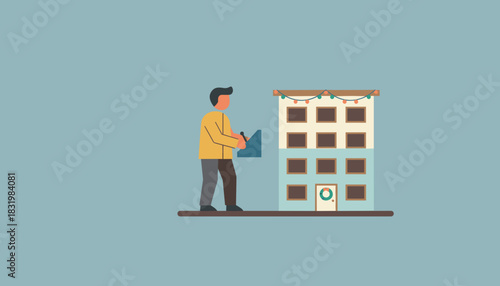 Man interacting with an apartment building decorated for winter holidays