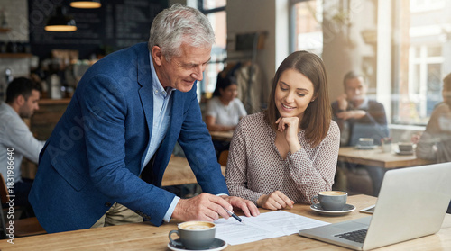 Business meeting in cafe: discussing documents and financial plans