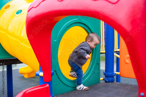 Little toddler enjoying time at playground outdoors