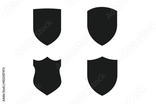 Four unique black shield shapes designed for various uses in graphics and branding without intricate details or patterns