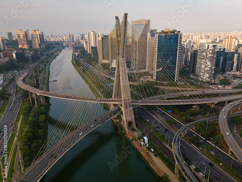 aerial view of a cable stayed bridge in Sao Paulo city with Pinheiros river during sunset