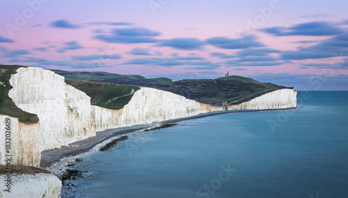 Blue hour evening view of Belle Tout lighthouse and Birling Gap from the cliff tops of the seven sisters on the east Sussex coast south east England UK