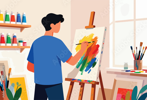 A person in a blue shirt paints on a canvas, surrounded by art supplies, brushes, and color palettes