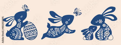 Charming blue silhouette bunnies with intricate floral patterns and butterflies celebrating easter spring