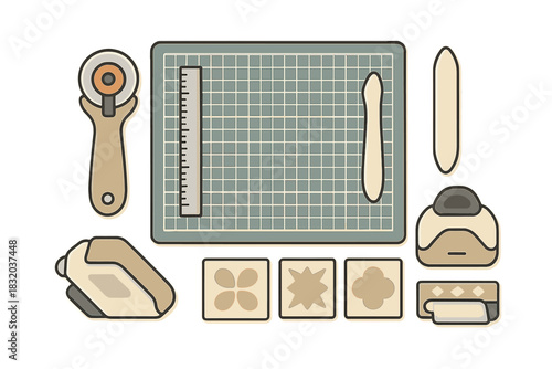 Crafting tools are neatly arranged on a cutting mat ready for creative projects