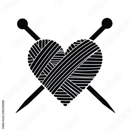 Black heart shape made of yarn with knitting needles craft