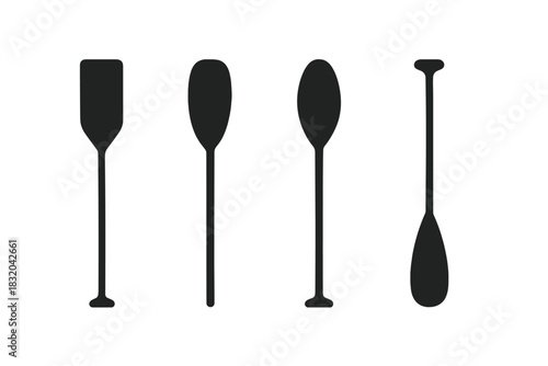 Various styles of paddles displayed in a row for water sports enthusiasts and boaters to consider
