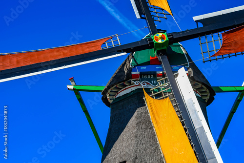 Detailed view of the mechanism and thatched roof of a 17th-century Dutch windmill.
