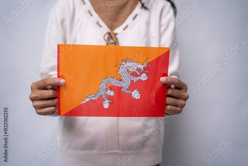 Person Holding the Traditional National Flag of Bhutan