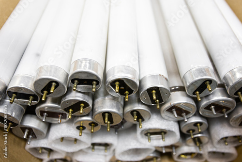 Used fluorescent lamp bases in a stack.