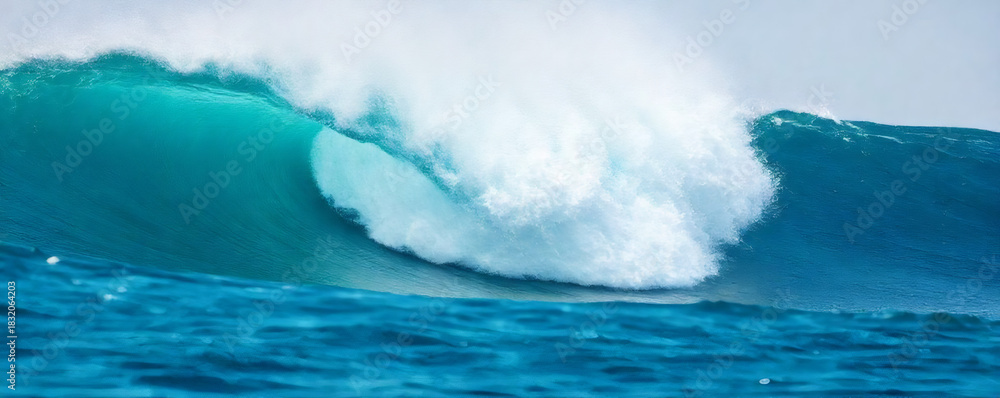 Fototapeta premium Ocean wave crashing against pristine beach with clear blue water on a sunny day