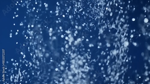 Abstract background of blue water droplets creating a dynamic pattern, texture, and effect