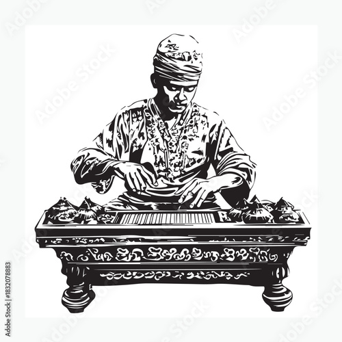 man sitting playing a gamelan instrument