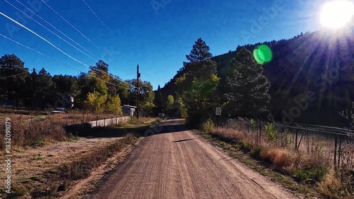 Looking for fall colors while driving into the scenic Sangre de Cristo Mountains of the Santa Fe National Forest at sunset, outside Las Vegas, New Mexico