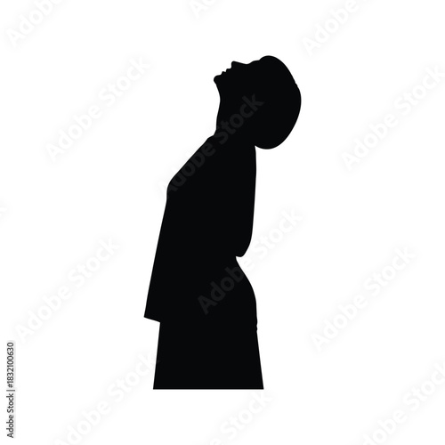 Silhouette of a woman wearing a hijab looking upwards with her head tilted back in contemplation