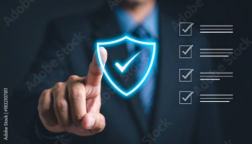 Businessman touches glowing shield with checkmark symbolizing security and verification