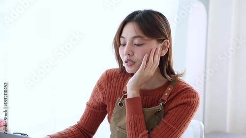 Small business coffee shop owner female working on bookkeeping at counter using laptop, reviewing financial data focus profit, strong responsibility, management skill, daily tasks, barista or employee