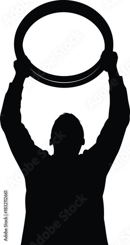 Silhouette of person holding up a ring victory