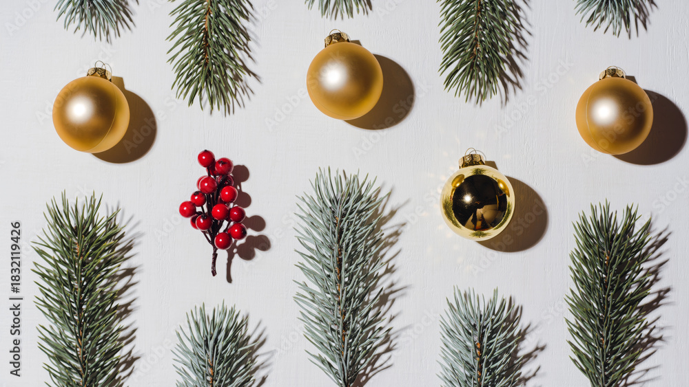 Obraz premium Creative Christmas Flat Lay with Pine Branches Gold Baubles and Red Berries on White