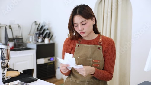 Young coffee shop owner feeling stressed while working on early business results, inexperienced entrepreneurs facing financial difficulty, lack learning, emotional pressure in small business startup