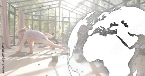 Fototapeta Doing deep lunges, four adults in workoutwear in glass studio with mats, blocks, globe, copy space