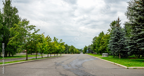 Quiet Tree-Lined Park Street in Victory Park on Poklonnaya Hill, Moscow, Russia, 10 August 2025