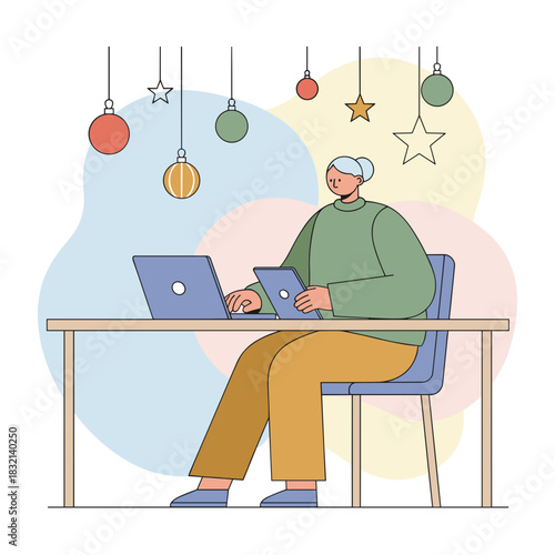 Woman works on laptop and tablet multitasking at a desk decorated for the holidays