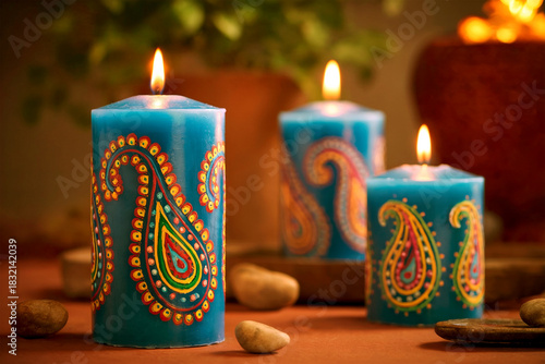 Decorative Blue Paisley Candles Lit in Warm Ambient Setting