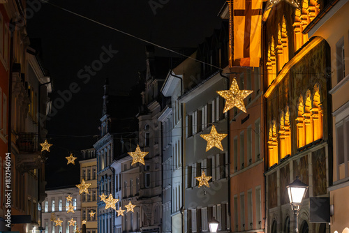 The streets of the Old Town are adorned with beautiful star-shaped Christmas lights at night. Konstanz, Baden-Württemberg, Germany.