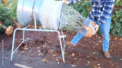 Fresh Christmas trees for sale at street market, warm lights and joyful holiday vibes.